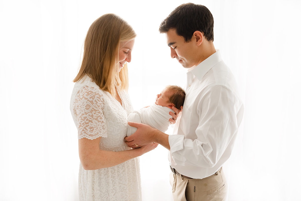 parents holding newborn baby during newborn photography session at boston photography studio